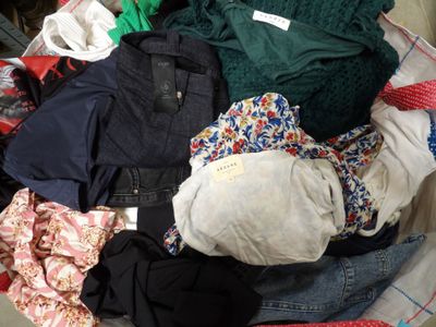 a pile of clothes in a basket on the floor