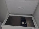 a white chest freezer sitting in the corner of a room