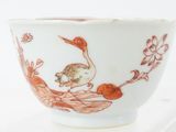 a bowl with a bird on it sitting on a table