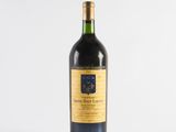 a bottle of wine sitting on top of a white table