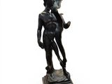 bronze statue of a boy with a pipe in his hand