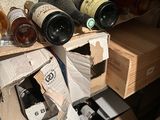 many bottles of wine sitting on a shelf in a room