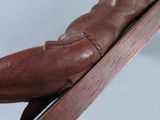 a wooden statue of a man on a ski board