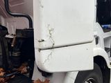 an image of a truck that has fallen leaves on the side