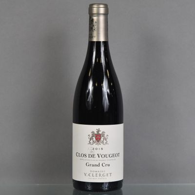 the bottle of red wine is sitting on a glass table
