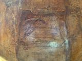 a large wooden bowl with writing on it on a table