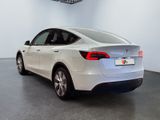 the back of a white tesla model s in a showroom
