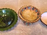two bowls and a bowl sitting on a table