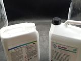 two containers of pharmol sitting on a table