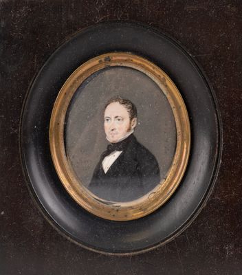 portrait of a man in a black suit and bow tie in a gold frame
