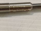 a close up of a metal screw on a white surface
