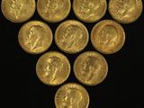 a close up of a bunch of gold coins on a black surface
