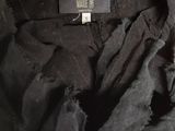 a close up of a black dress with a label on it