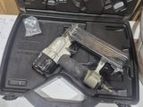 a gun that is sitting in a case on a table