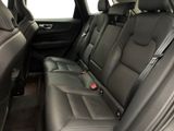 the back seats of a black car with a red tag on it