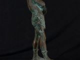 bronze statue of a man holding a baseball bat on a marble base