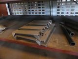 many different types of steel pipes on a table