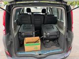 the back of a van with luggage in the trunk of it