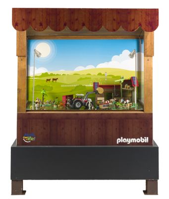 un présentoir de jouets comprenant un tracteur et un décor de ferme