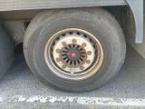 a close up of a flat tire on the side of a truck