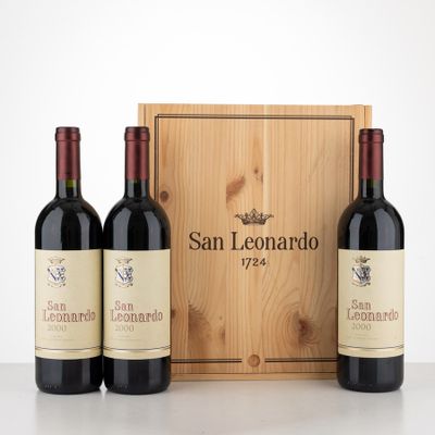 three bottles of wine in front of a wooden box on a table