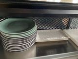 several plates stacked on top of each other in a kitchen