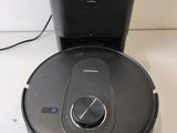 an image of a robotic vacuum cleaner sitting on top of a table