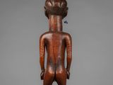 a wooden statue of a man with a head and torso