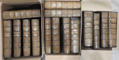 several old books are sitting in a box on a table
