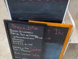 a chalk board with a menu on it next to a chalk board with a menu written on it