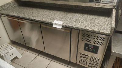 a stainless steel counter top with a microwave on top of it