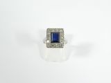 a blue sapphire and diamond ring on a white background
