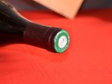 a bottle of wine sitting on a red cloth