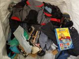 a bag full of clothes and a book on the bed