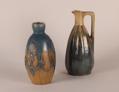 two vases sitting next to each other on a white surface