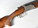 a close up of a rifle on a table with a white background