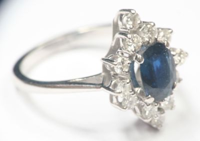 a ring with a blue stone surrounded by white diamonds