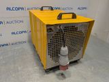 a close up of a yellow machine on a gray floor