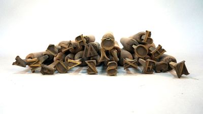 a lot of small wooden figurines sitting on a white surface