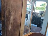 a wooden cabinet in the corner of a room