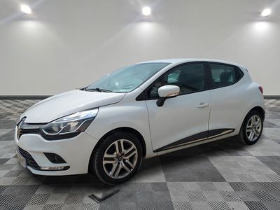 a white car is parked in a room with a checkered floor