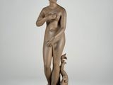 an image of a bronze statue of a woman holding a dog