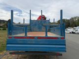 a blue truck that is parked on the side of the road