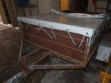 a bed that is sitting on a cart in a room