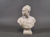 statue of a woman with a bun on her head on a white base