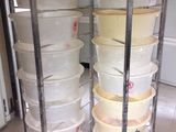 a lot of bowls stacked on a cart in the kitchen
