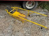 a yellow cart that is sitting on the ground