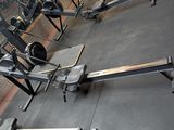 a picture of a gym room with a bench and weights
