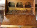 a small wooden desk with a drawer on top of it