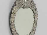 a mirror that is hanging on the wall in the room